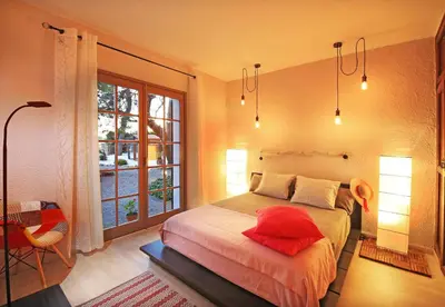 a bedroom with a bed with a red pillow on it at Casa Rural Els Pins in Sant Marçal