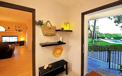 a living room with a door open to a balcony at Casa Rural Els Pins in Sant Marçal