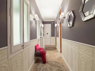 a hallway with a red chair and a mirror at Exclusive apartment for 4 people in characteristic area of Barcelona in Barcelona