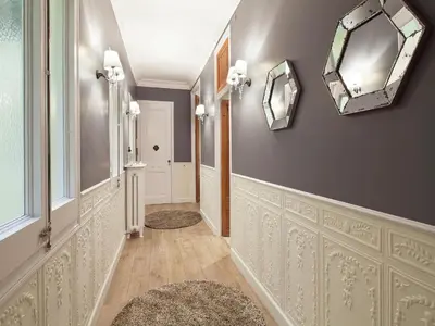 a hallway with two mirrors on the wall at Exclusive apartment for 4 people in characteristic area of Barcelona in Barcelona