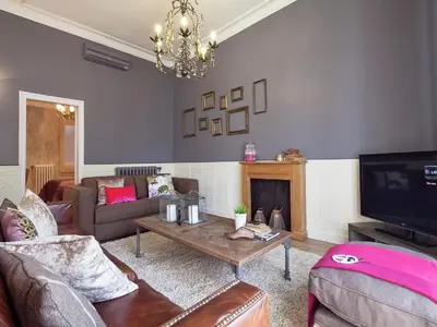 a living room with a couch and a tv at Exclusive apartment for 4 people in characteristic area of Barcelona in Barcelona