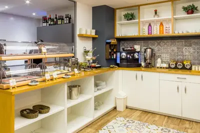a kitchen with white cabinets and a counter at Apart-Suites Hostemplo in Barcelona
