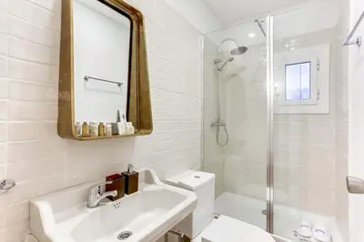 a bathroom with a sink and a toilet and a mirror at Sweett - Aragon in Barcelona
