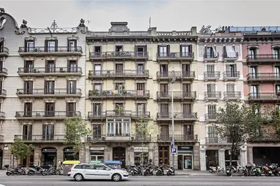 a large building with motorcycles parked in front of it at Sweett - Aragon in Barcelona