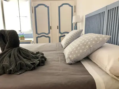 a bed with a blanket and pillows on it at Vilamarlux II in Vilassar de Mar