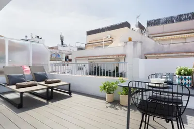a balcony with a table and chairs on a building at Sitges Group Calm Beach in Sitges