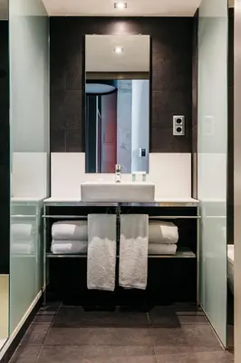 a bathroom with a sink and a mirror and towels at Barcelona Apartment Republica in Barcelona