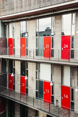 a facade of an apartment building with red doors at Barcelona Apartment Republica in Barcelona