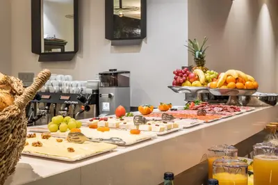 a buffet line with many different types of food at Arya Stadium Hotel in Barcelona