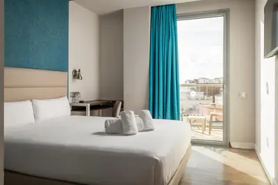 a hotel room with a bed and a large window at Arya Stadium Hotel in Barcelona
