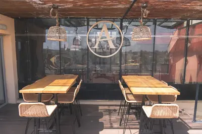 a group of tables and chairs in a restaurant at Arya Stadium Hotel in Barcelona