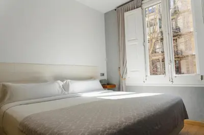 a bedroom with a bed and a window at Cosmopolitan Boutique Rambla in Barcelona