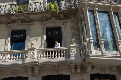 a man looking out the window of a building at Hotel Actual in Barcelona