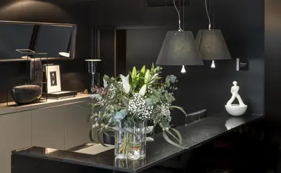 a vase of flowers on a counter in a kitchen at Hotel Actual in Barcelona