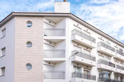 a white building with balconies on it at Apartments Sorrabona in Pineda de Mar