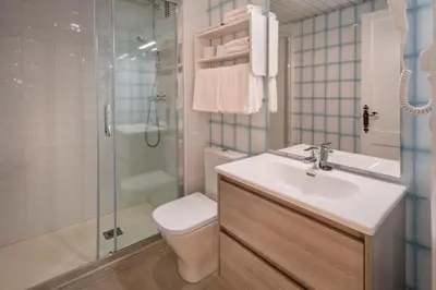 a bathroom with a toilet and a sink and a shower at Apartments Sorrabona in Pineda de Mar