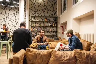 a group of men sitting on couches in a room at Safestay Barcelona Gothic in Barcelona
