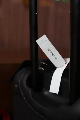 a piece of paper sitting on top of a suitcase at New Hotel Colon in Mataró