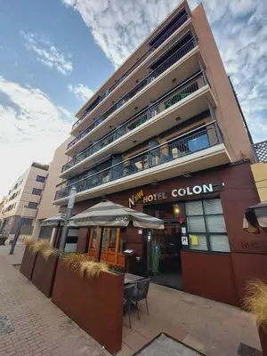 a hotel building with a table outside of it at New Hotel Colon in Mataró