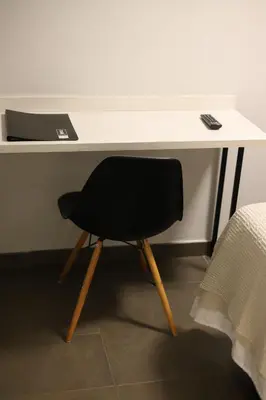 a black chair sitting in front of a desk at New Hotel Colon in Mataró