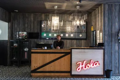 a man sitting at a bar in a restaurant at New Hotel Colon in Mataró