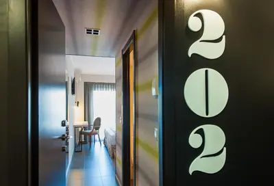 a hallway with a room with a bed and a table at New Hotel Colon in Mataró