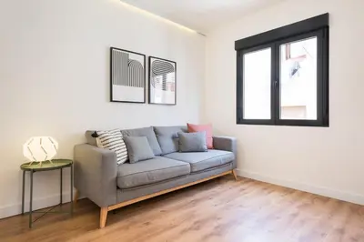 a living room with a couch and a window at Urban Chill Apartments by Olala Homes in Hospitalet de Llobregat