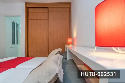 a bedroom with a bed and a table with a couch at Elegantniy Poble Sec in Barcelona