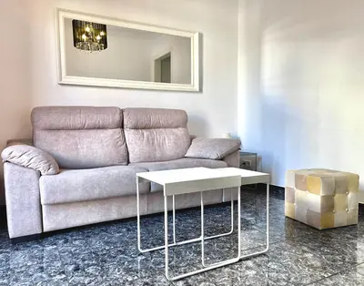 a living room with a couch and a table at Elegantniy Poble Sec in Barcelona