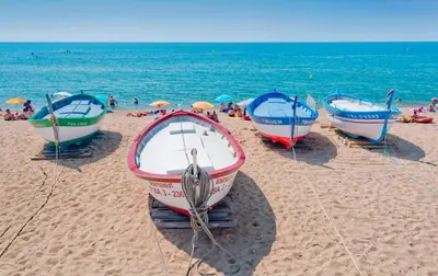 a group of boats sitting on the beach at Hotel Sabiote in Pineda de Mar