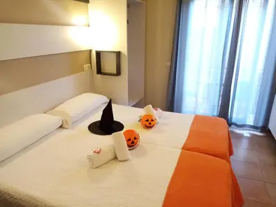 a bedroom with a bed with two pumpkins on it at Hostal Termes in Sitges