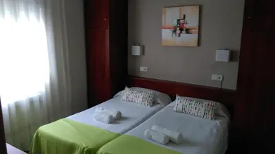 a bedroom with two beds with towels on them at Hostal Termes in Sitges