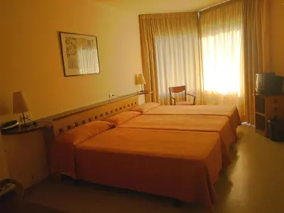 a hotel room with two beds and a television at Hotel Montmeló in Montmeló