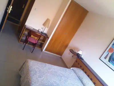 an overhead view of a bedroom with a bed and a desk at Hotel Montmeló in Montmeló
