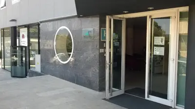 a building with a round mirror on the side of it at Hotel Montmeló in Montmeló