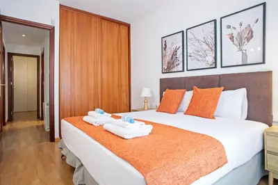 a bedroom with a large bed with two towels on it at Alcam El Coll in Barcelona