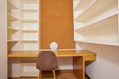 a desk with a chair in a room with shelves at Alcam El Coll in Barcelona