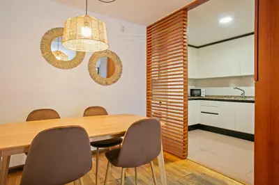 a dining room with a wooden table and chairs at Alcam El Coll in Barcelona