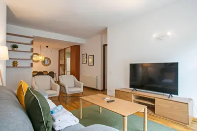 a living room with a couch and a flat screen tv at Alcam El Coll in Barcelona