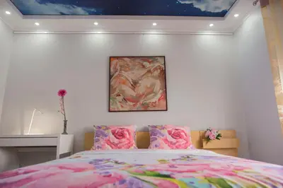 a bedroom with a bed with a painting on the wall at Camp Nou, Europa Fira - modern two-bedroom apartment with heating in Hospitalet de Llobregat
