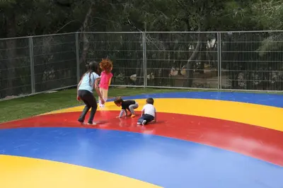 a group of children playing on a trampoline at Camping Vilanova Park in Vilanova i la Geltrú