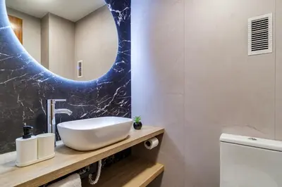 a bathroom with a sink and a mirror at Spacious 4 Bedroom Apartment Fira BCN & Camp Nou in Barcelona