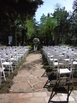a row of white chairs lined up for a wedding at Masia Vista Hermosa in Vallromanas