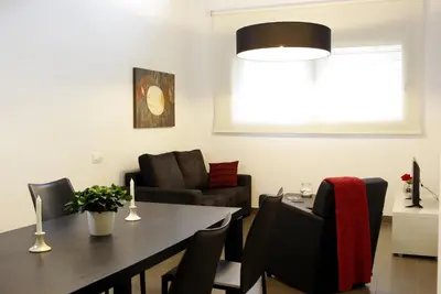 a living room with a dining room table and a couch at 08028 Apartments in Barcelona