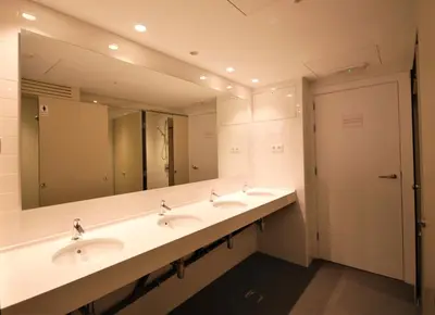 a bathroom with two sinks and a large mirror at Ten To Go Hostel in Barcelona