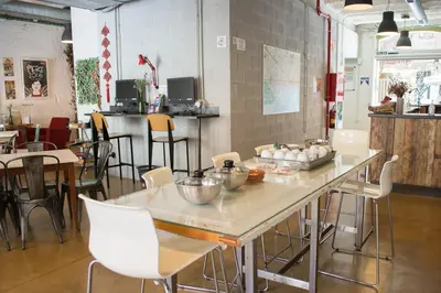 a restaurant with a table with bowls on it at Ten To Go Hostel in Barcelona