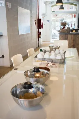 a counter with bowls of food on a table at Ten To Go Hostel in Barcelona
