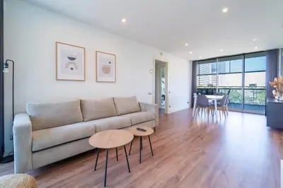 a living room with a couch and a table at Unique Rentals-Seafront Luxe Suites in Barcelona