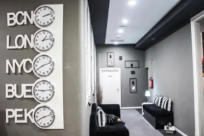 a group of clocks on a wall in a room at Hostal Boutique Khronos in Barcelona