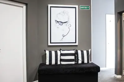 a room with a couch with a picture of a woman at Hostal Boutique Khronos in Barcelona